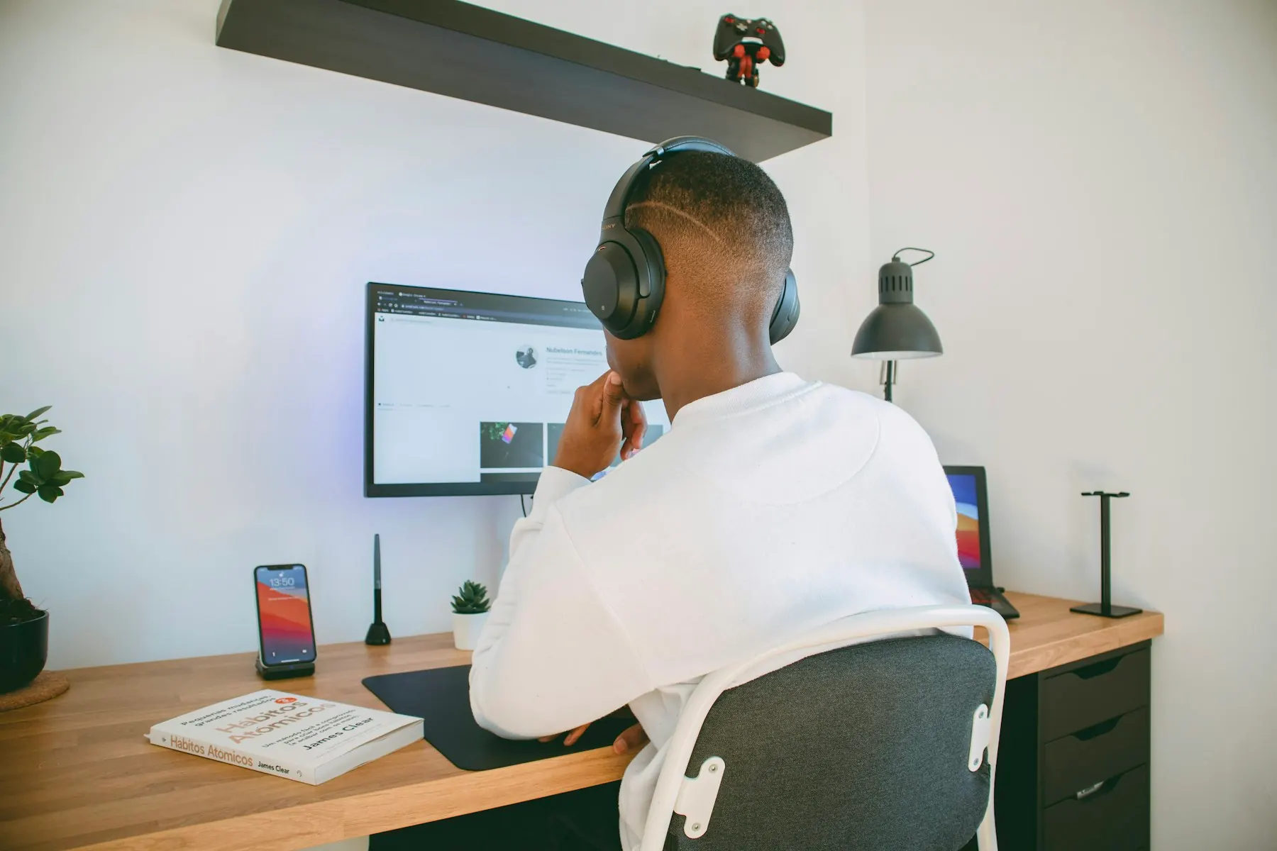 Someone working at a laptop in a home workspace
